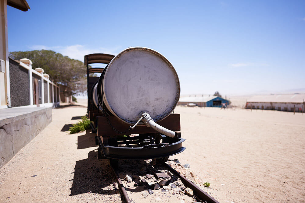 The picture shows an old train in Kolmanskop