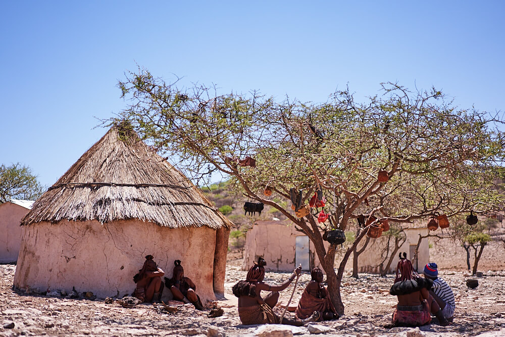 The picture shows a typical everyday scene of a Himba village