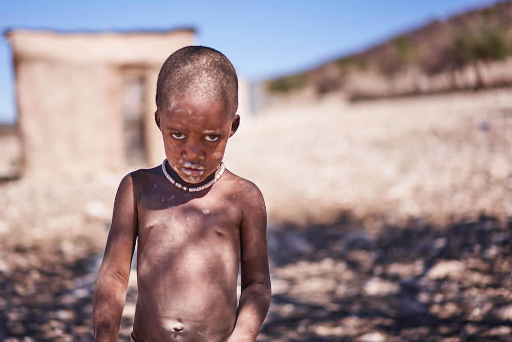 The picture shows a young Himba